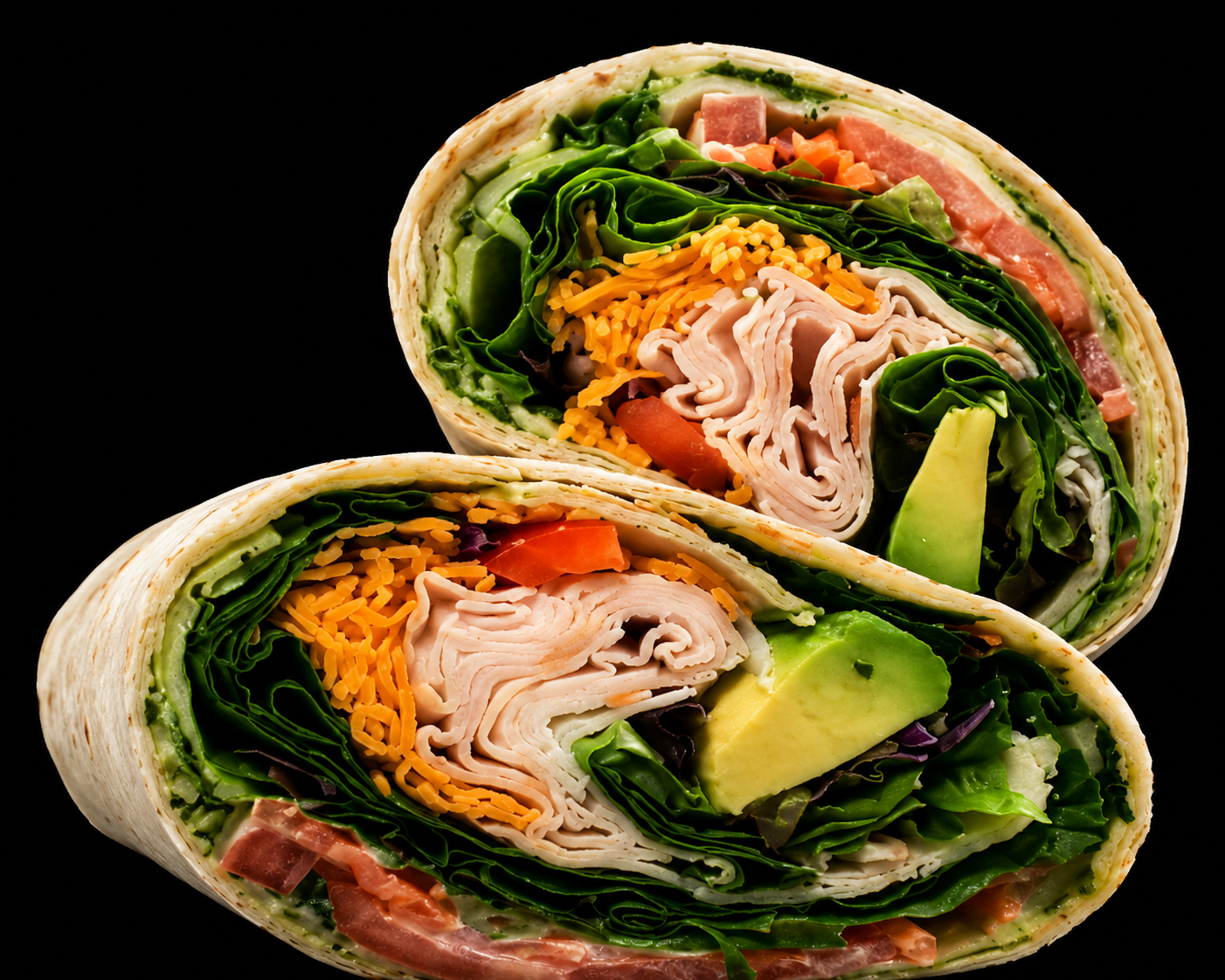 Turkey avocado wrap cut in half with spinach, cheddar, tomato and avocado